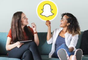 Woman holding emoticons on a couch